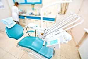 Professional Dentist tools and chair in the dental office.